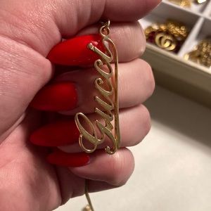 Gucci logo charm on a necklace in gold